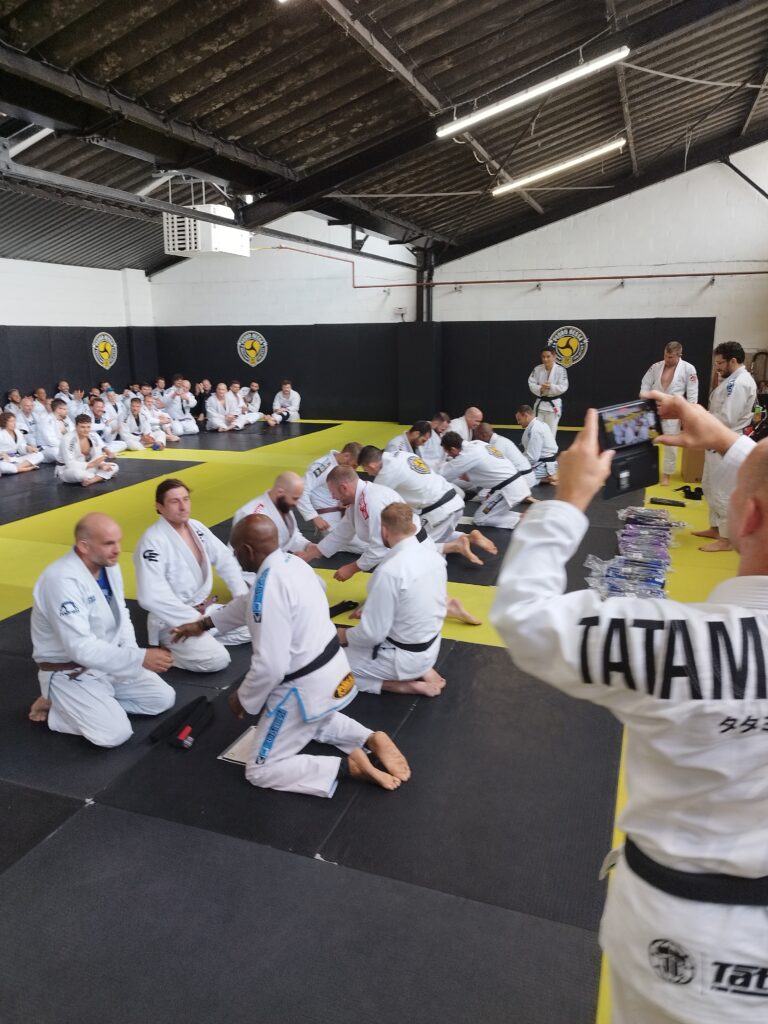 A Brazilian jiu-jitsu class practises techniques on the mat.