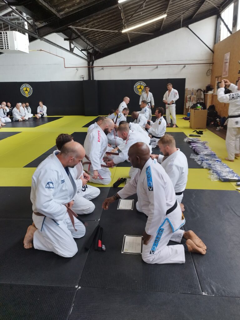 Students take part in a group jiu-jitsu training session.