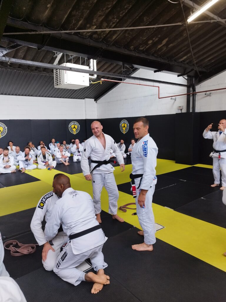 Training partners practise grappling techniques on the mat.