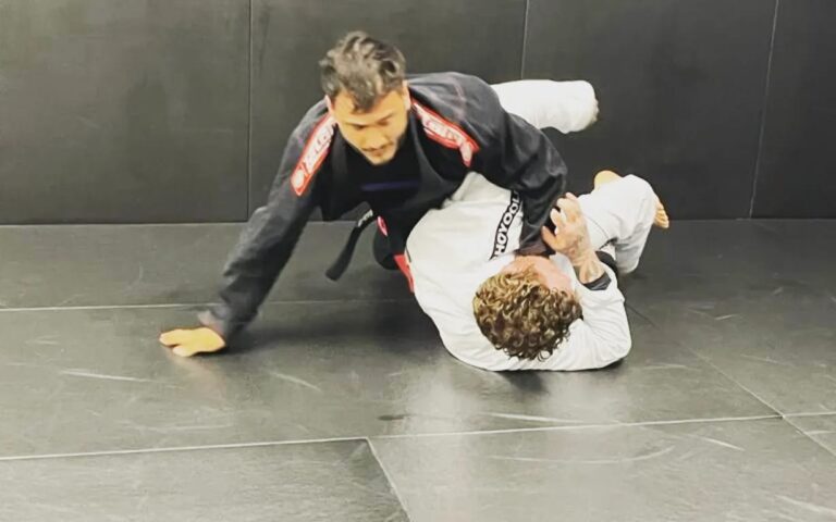 Training partners practise grappling on the mat.