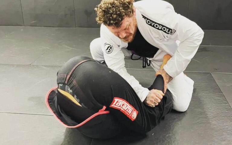 Two students drill a Brazilian jiu-jitsu ground technique.