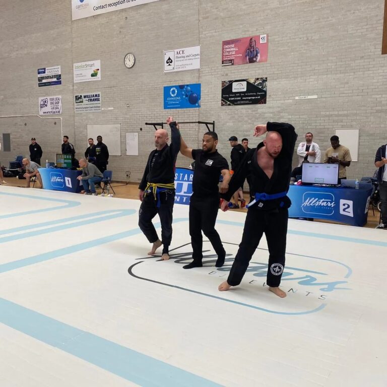 Students practise a ground position during class.