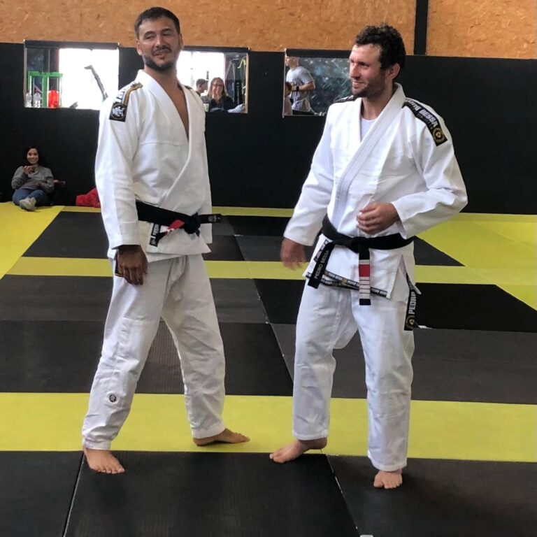 Training partners work through a grappling technique.