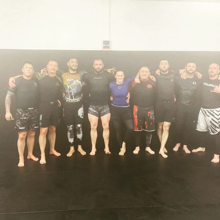 Young students stand together after a kids jiu-jitsu class.