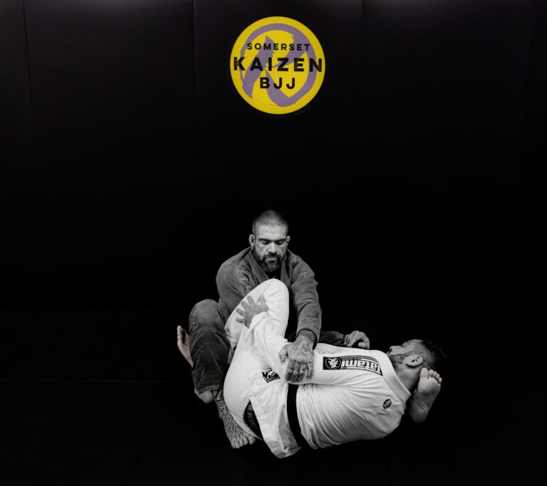 Black-and-white photo of two students sparring on the mat.