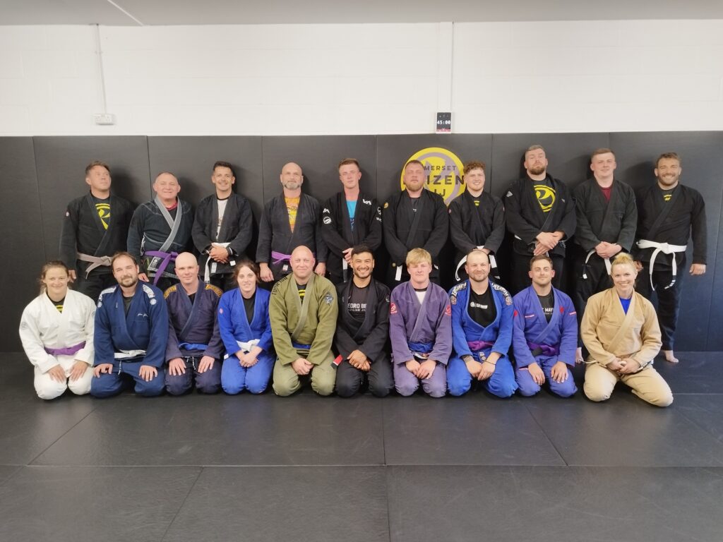 Students pose together after a Brazilian jiu-jitsu training session at Kaizen BJJ.