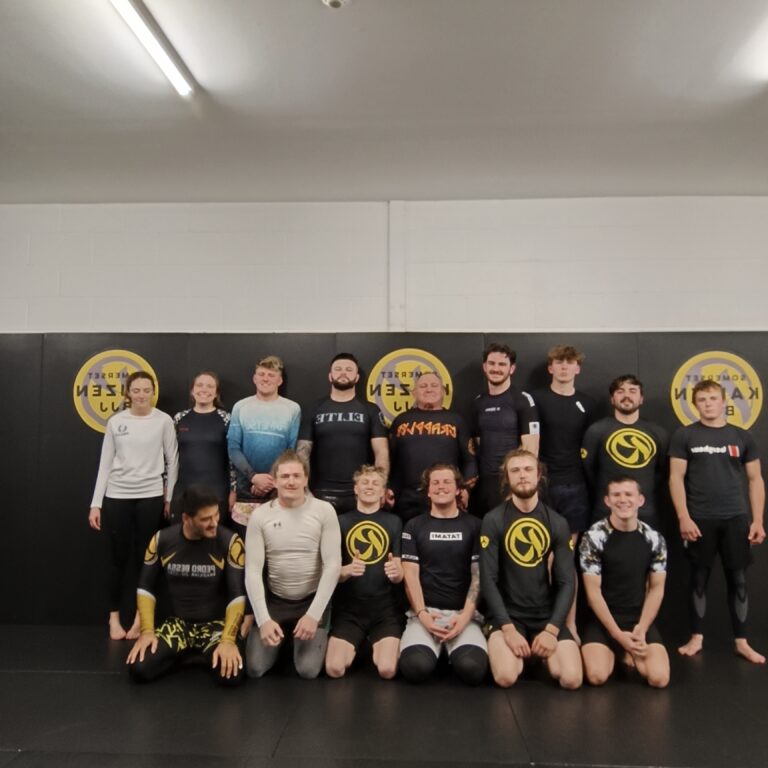 Kaizen BJJ students and teammates pose together after training.